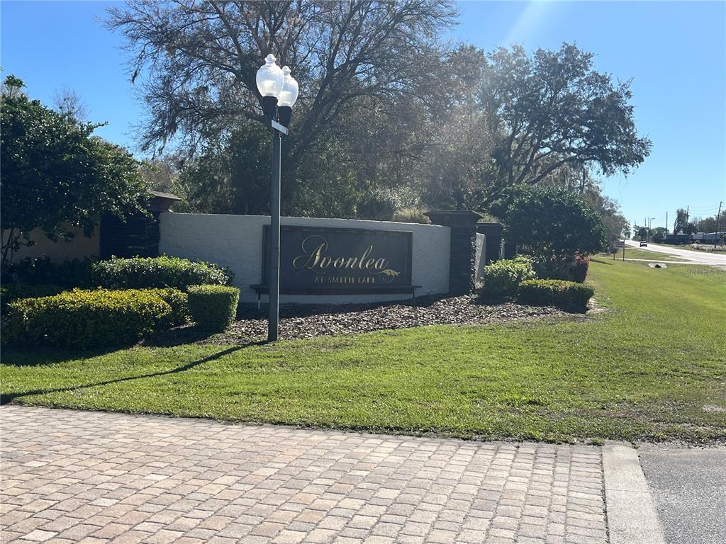 A stone monument sign for Avonlea at Smith Lake stands beside a paved driveway — 000 SE 118TH LANE, BELLEVIEW, FL