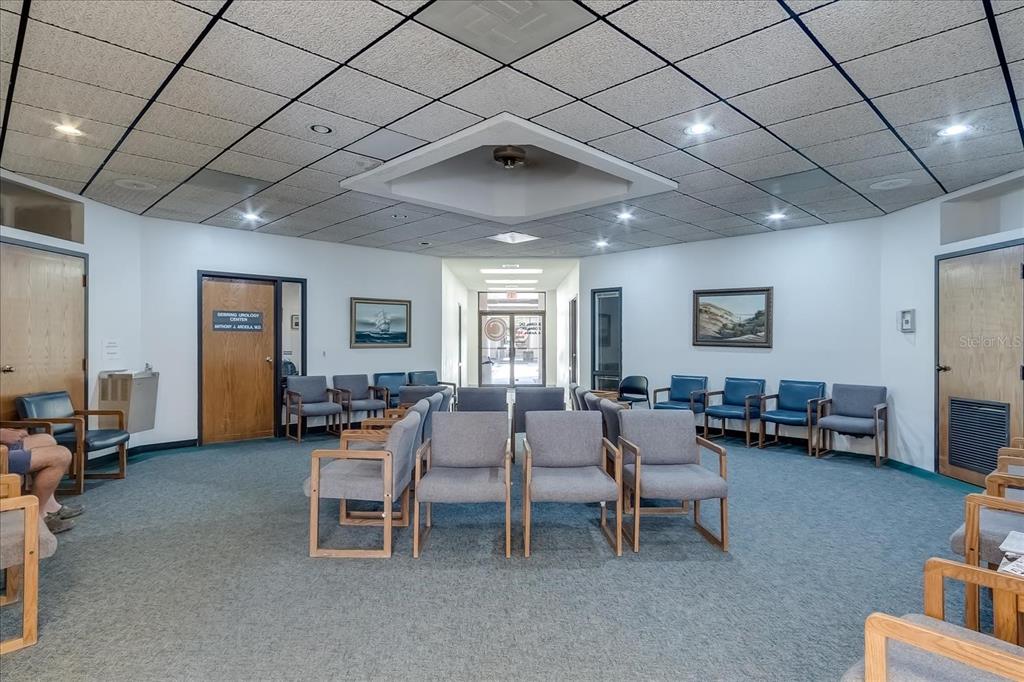 A waiting room with gray chairs, carpeted floors, and a drop ceiling with recessed lighting — 6801 US 27 HIGHWAY N UNIT C4, SEBRING, FL