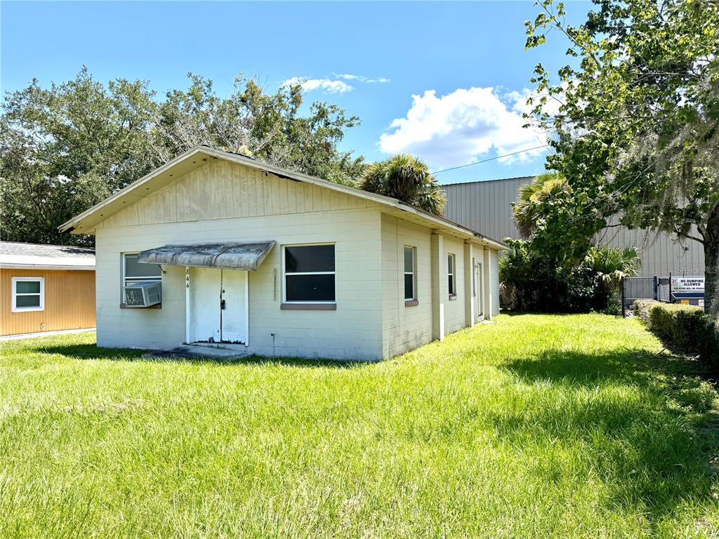 A single-story, light-colored building with a metal awning over the front entrance and a lawn — 844 KLONDIKE STREET, WINTER GARDEN, FL
