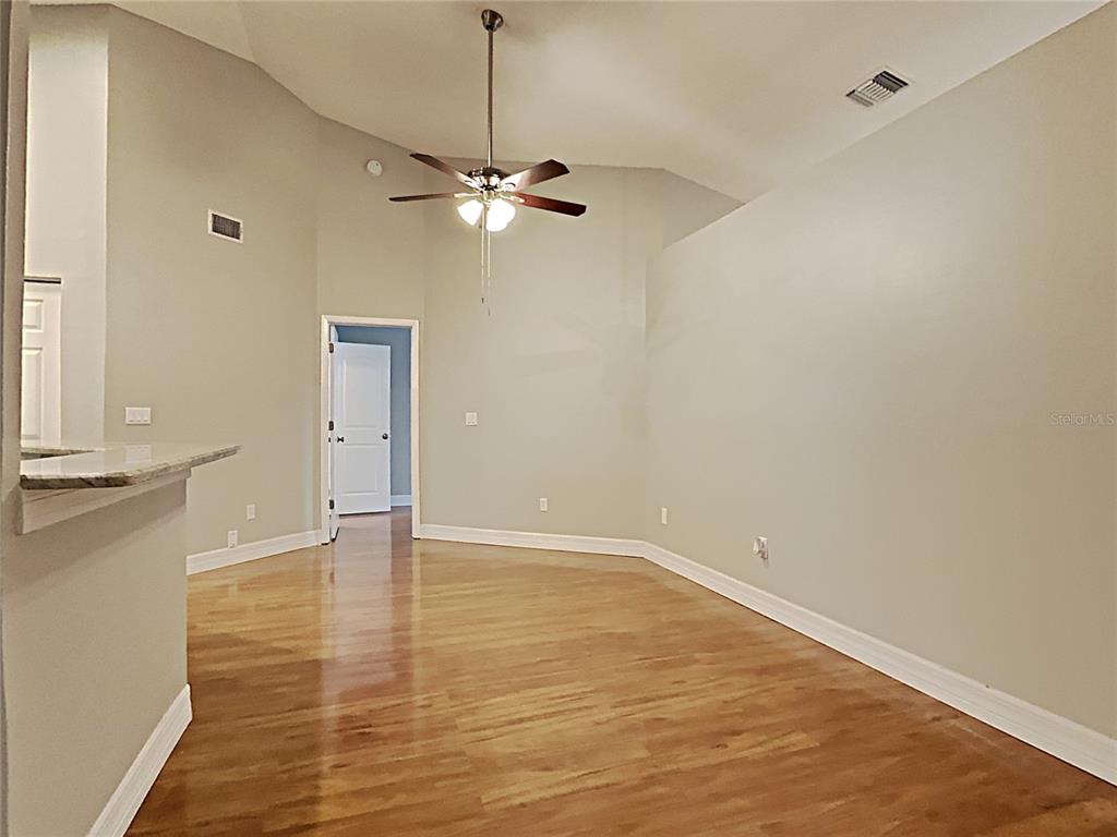 An empty room with light-colored walls, wood-look flooring, and a ceiling fan — 1237 BARMERE LANE, BRANDON, FL