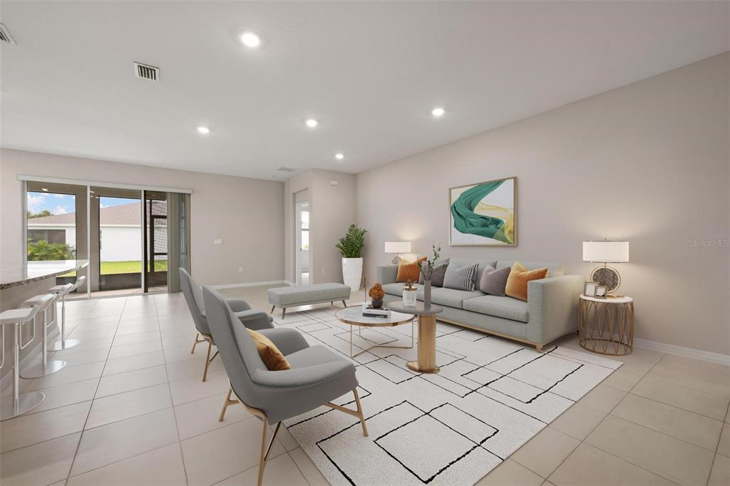 An open-concept living and dining area features tile flooring, recessed lighting, and a kitchen island — 431 158TH STREET E, BRADENTON, FL