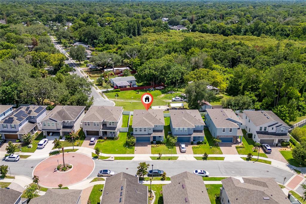 An aerial view shows a row of suburban houses with a red location pin — 1259 ASH TREE COVE, CASSELBERRY, FL