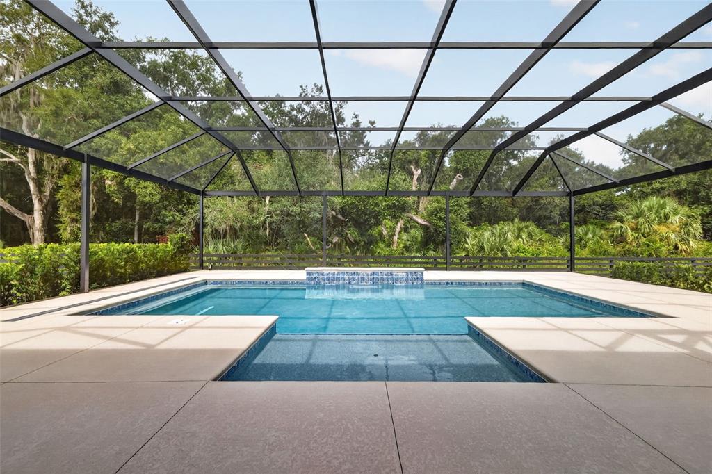 A white single-story house with a three-car garage and a landscaped front yard — 724 SHIVERS LOOP, THE VILLAGES, FL