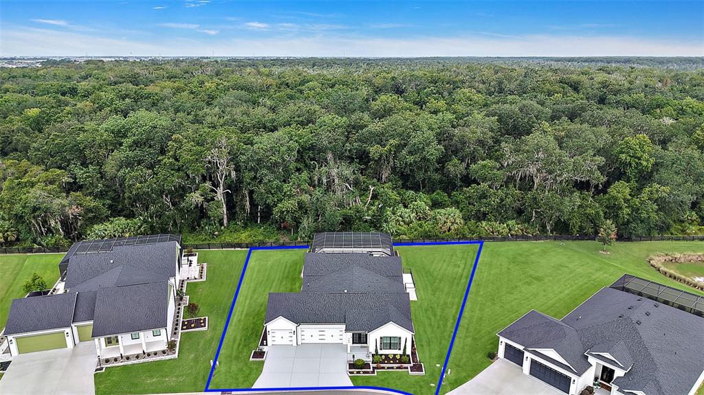 A screened-in swimming pool and spa with a tiled water feature and surrounding concrete deck — 724 SHIVERS LOOP, THE VILLAGES, FL