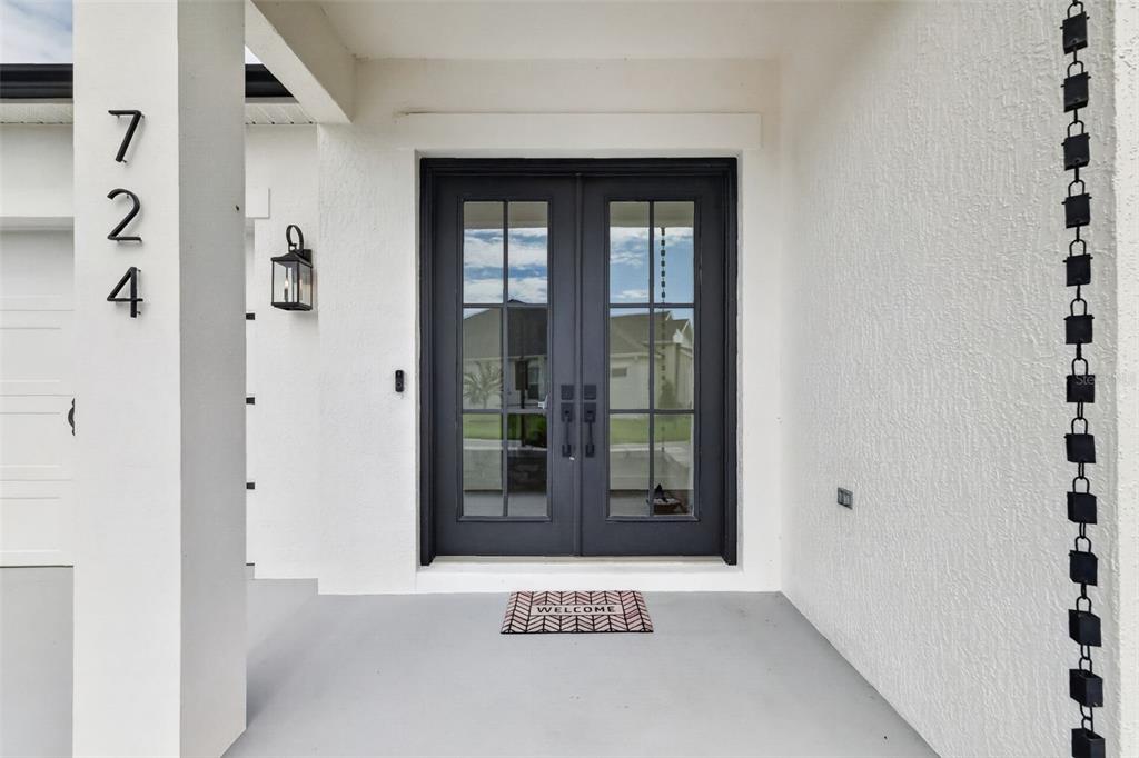 An aerial view shows a suburban house with a screened pool and a large backyard — 724 SHIVERS LOOP, THE VILLAGES, FL