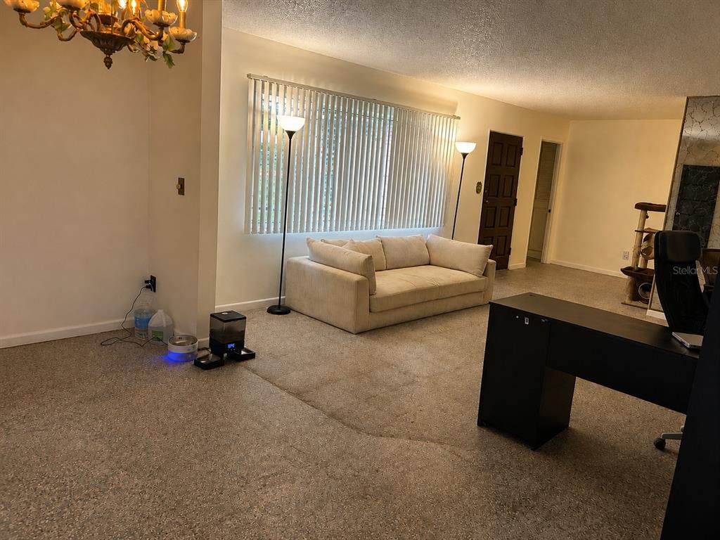 A living room features a beige sofa, two floor lamps, and a black desk — 315 LAKE SEMINARY CIRCLE, MAITLAND, FL