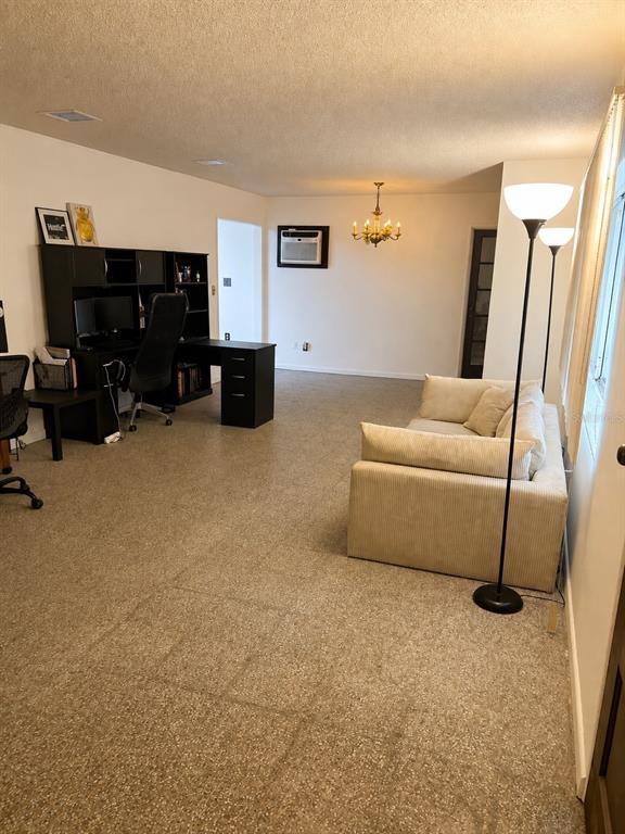 A living room and office area with a beige sofa, desk, and terrazzo flooring — 315 LAKE SEMINARY CIRCLE, MAITLAND, FL