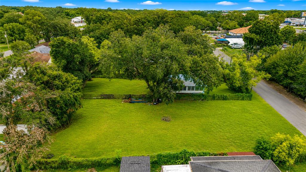 An aerial view shows a large, grassy residential lot with a house and mature trees — 2743 LUCILLE STREET, KISSIMMEE, FL