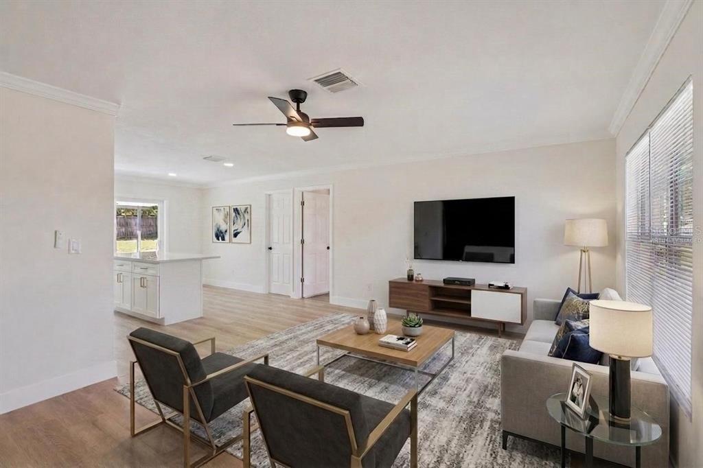 A single-story house with a white exterior, a concrete driveway, and a wooden fence — 2715 TIMBERLAKE AVENUE, DELTONA, FL