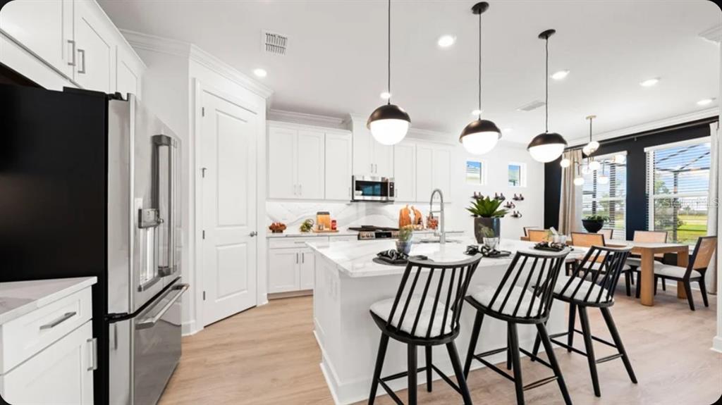This floor plan shows a single-story home with a two-car garage, lanai, and three bedrooms — 7424 MOONBEAM AVENUE, SARASOTA, FL