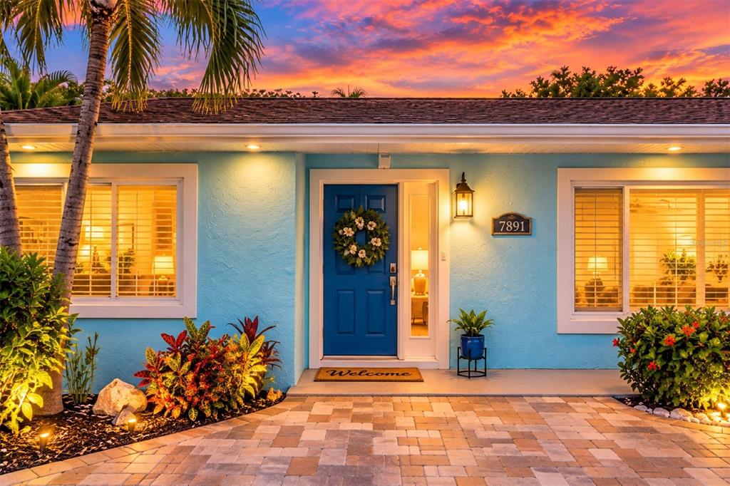 An aerial view shows a teal house with a brown roof near a canal — 7891 4TH AVENUE S, ST PETERSBURG, FL