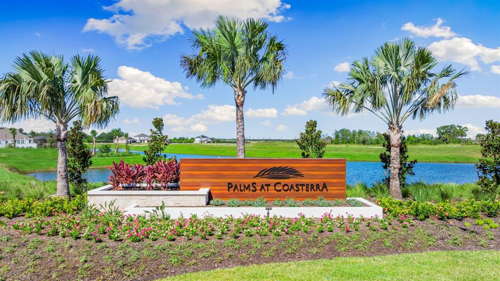 A wooden sign reading Palms at Coasterra stands before a pond and three palm trees — 12755 DOCKYARD TRAIL, PALMETTO, FL
