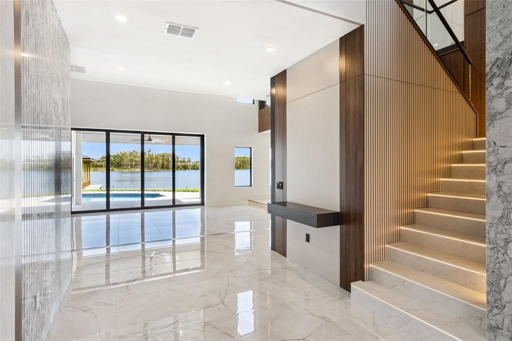 This is a rendering of a modern kitchen featuring wood cabinetry and a stone island — 9117 BAY POINT DRIVE, ORLANDO, FL
