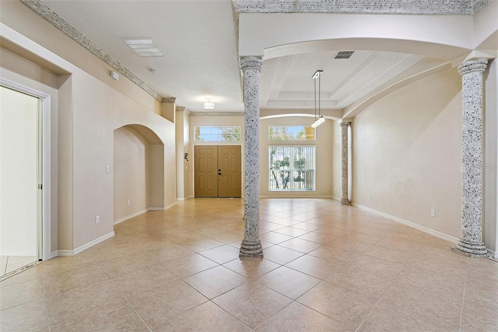 A kitchen features dark wood cabinets, a central island, light countertops, and tile flooring — 2436 FAWNLAKE TRAIL, ORLANDO, FL