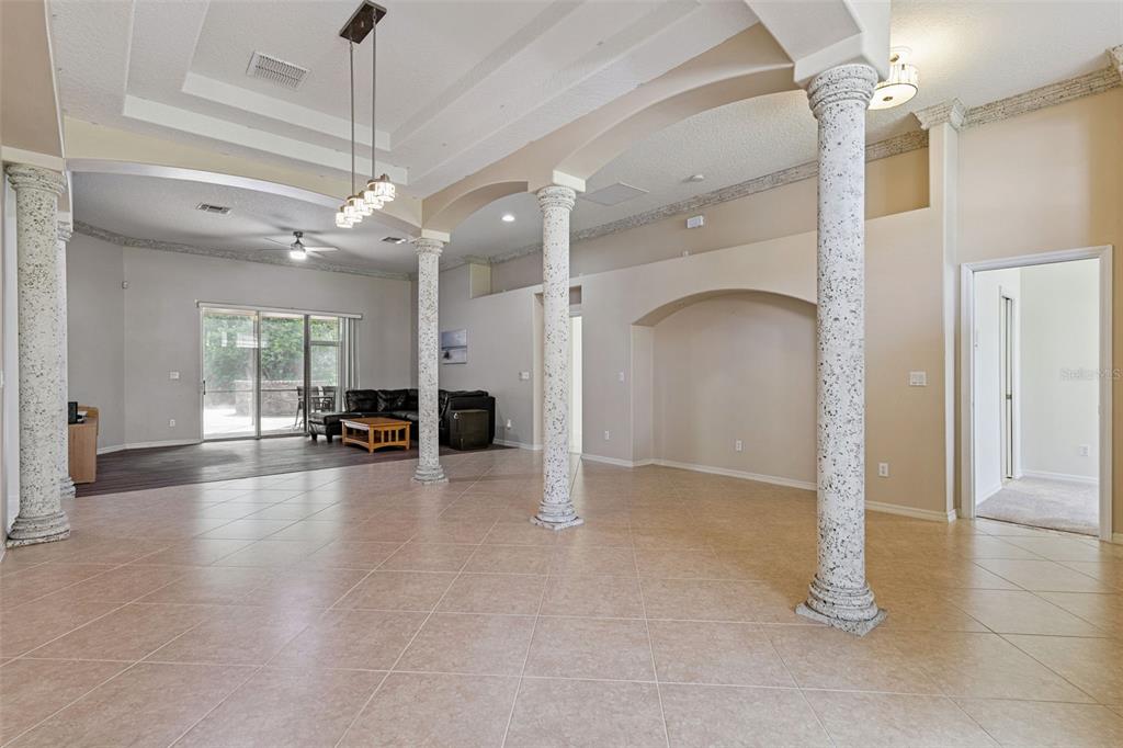 A backyard patio features a brick floor, a stone fire pit, and built-in concrete benches — 2436 FAWNLAKE TRAIL, ORLANDO, FL