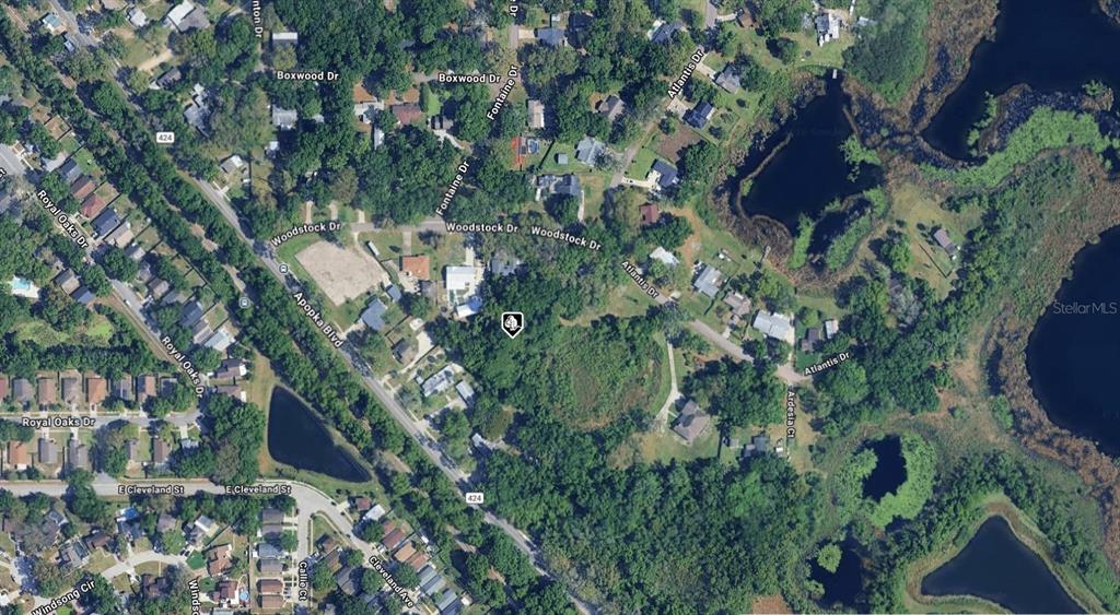 This is an aerial map view of a wooded residential area with surrounding streets and lakes — 1528 ISABEL CIRCLE, APOPKA, FL