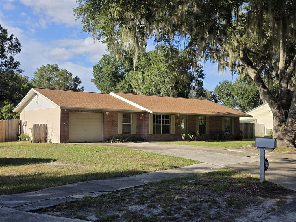 A stone monument sign for Imperial Lakes stands near a palm tree and manicured hedges — 5045 MISTY LAKE DRIVE, MULBERRY, FL