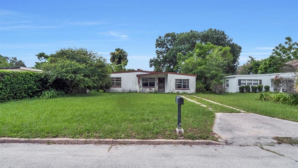 A single-story white house with a front lawn, a mailbox, and a concrete driveway — 1416 BORDER DRIVE, WINTER PARK, FL