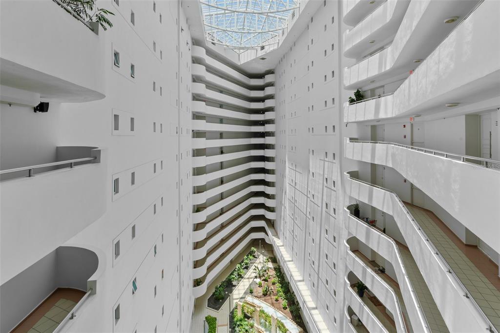 An interior view of a multi-story building atrium with tiered balconies and a glass ceiling — 550 AVE DE LA CONSTITUCION UNIT 1010, SAN JUAN, PR