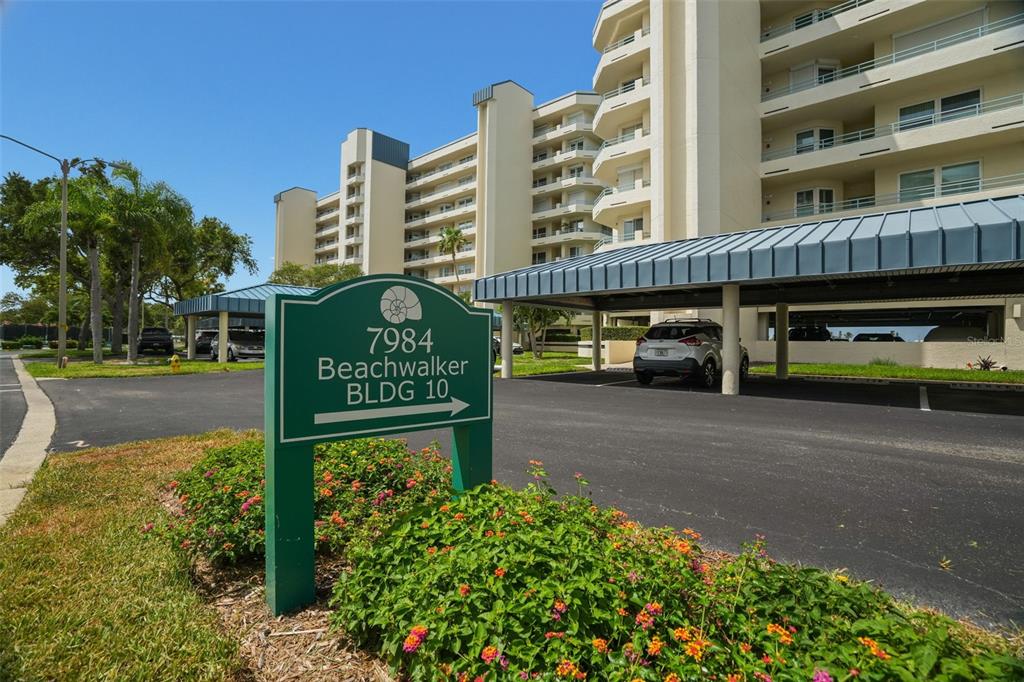 An aerial view shows tennis courts, a swimming pool, a marina, and surrounding residential buildings — 7984 SAILBOAT KEY BOULEVARD S UNIT 306, SOUTH PASADENA, FL