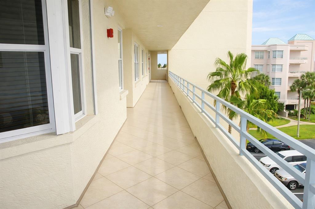 A covered entryway features a bay window with shutters and a glass storm door — 7984 SAILBOAT KEY BOULEVARD S UNIT 306, SOUTH PASADENA, FL