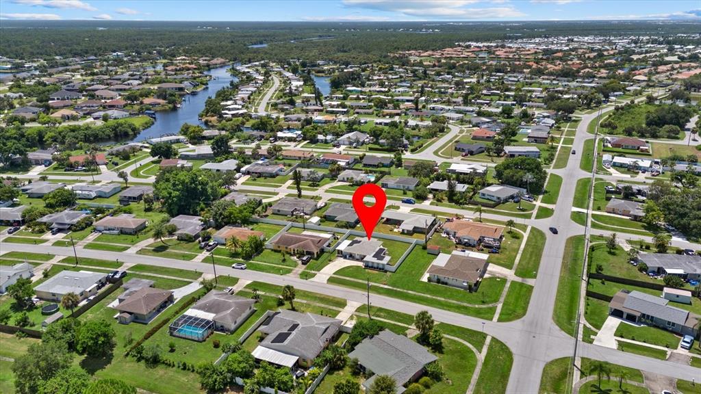 An aerial view shows a residential neighborhood with a red pin marking a specific house — 6315 JORDAN STREET, NORTH PORT, FL