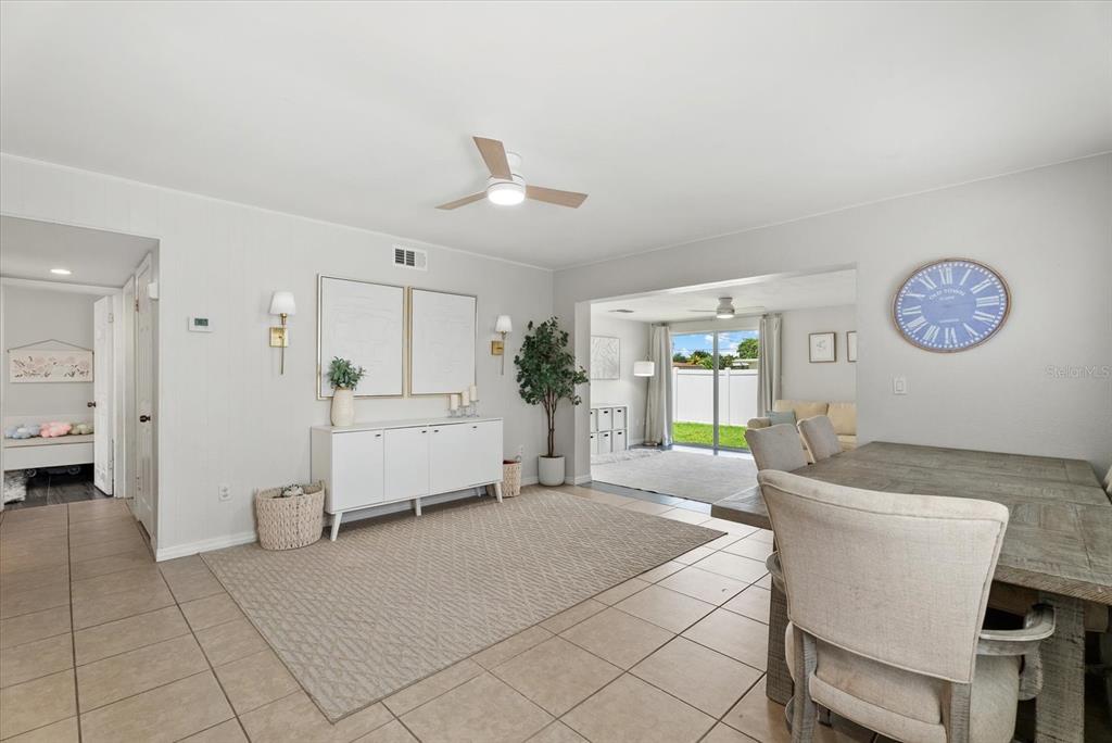 A dining area with tile floors, a wooden table, and a white sideboard cabinet — 6315 JORDAN STREET, NORTH PORT, FL