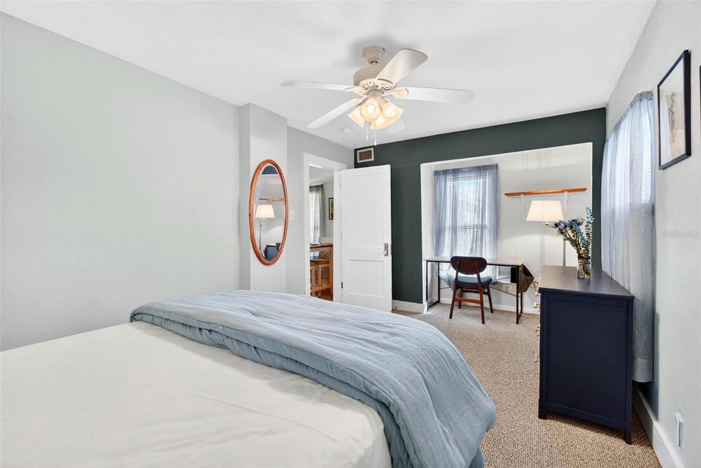 A bedroom features a bed, a desk in a recessed nook, and a ceiling fan — 509 29TH AVENUE S, ST PETERSBURG, FL