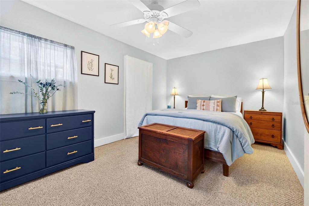 A bedroom features a blue dresser, a wooden chest, and a bed with blue bedding — 509 29TH AVENUE S, ST PETERSBURG, FL