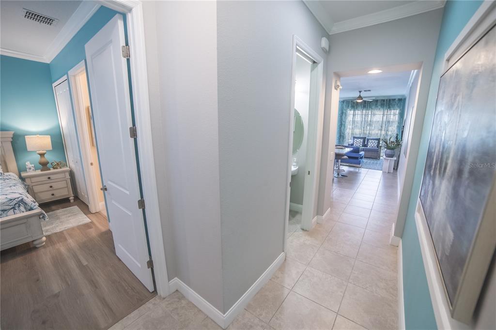 A hallway with tile flooring leads to a living area, with a bedroom door visible — 159 CAPTIVA DRIVE, DAVENPORT, FL