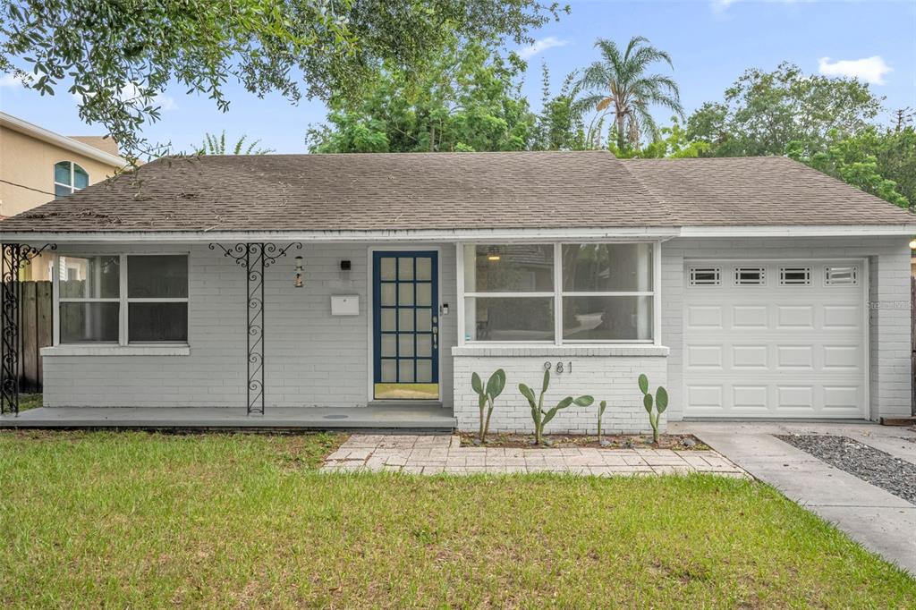 A kitchen features dark green cabinets, a stainless steel dishwasher, and a window above the sink — 981 ARAGON AVENUE, WINTER PARK, FL
