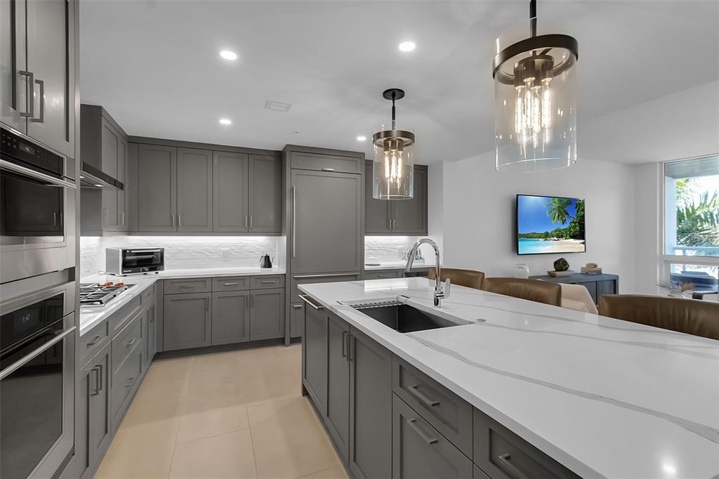 A bright living and dining area features white walls, a woven coffee table, and floor-to-ceiling windows — 1035 SEASIDE DRIVE UNIT 308, SARASOTA, FL