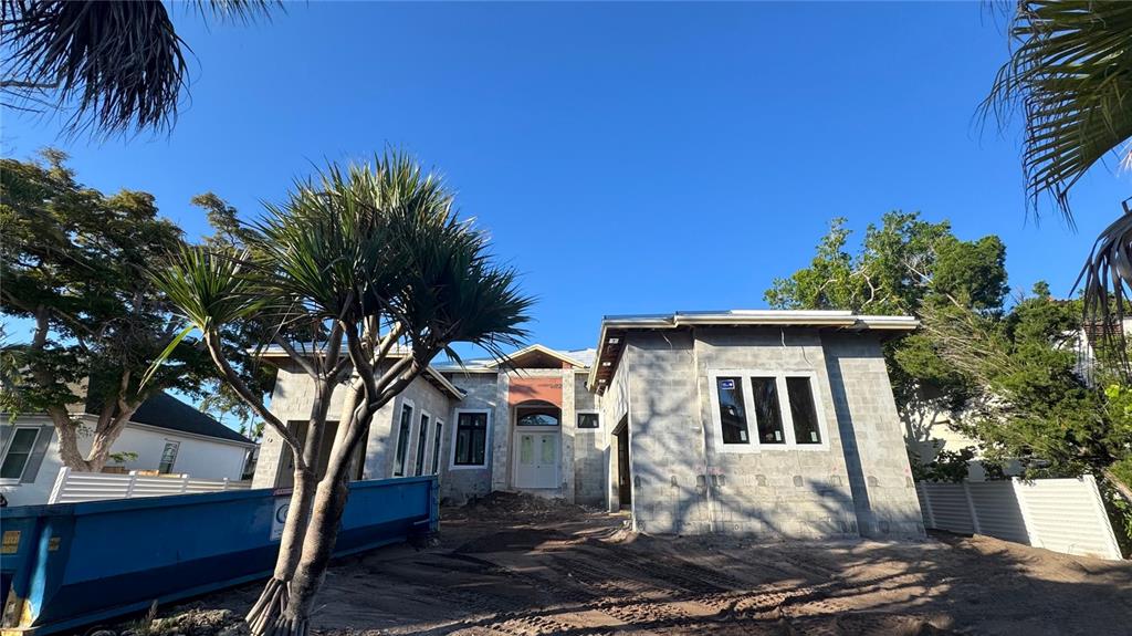 A single-story house under construction features concrete block walls, a front entrance, and a dumpster — 838 NORSOTA WAY, SARASOTA, FL
