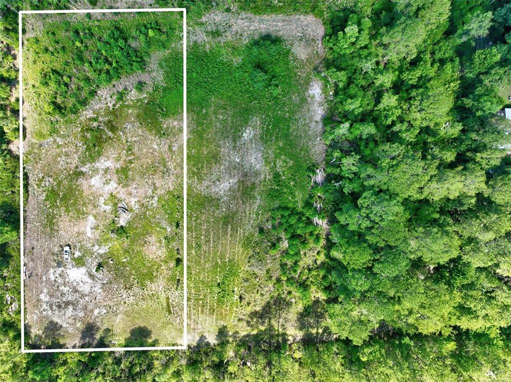 An aerial view shows a rectangular plot of land partially outlined in white — KINGS ESTATE ROAD, ST AUGUSTINE, FL