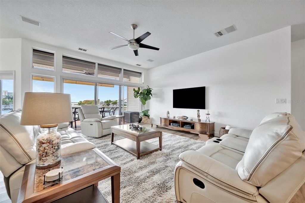 An aerial view of a multi-story waterfront house with a brown roof and palm trees — 5918 SKIMMER POINT BOULEVARD S, GULFPORT, FL
