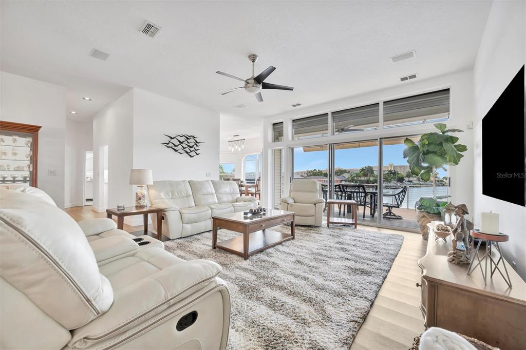 A multi-story waterfront house features a swimming pool, a private dock, and a boat lift — 5918 SKIMMER POINT BOULEVARD S, GULFPORT, FL