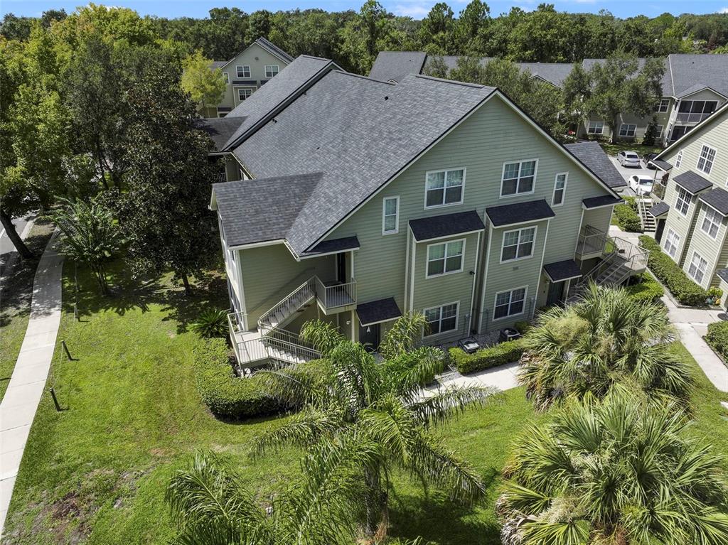 An aerial view shows a multi-story apartment building with green siding and a shingled roof — 3721 S LAKE ORLANDO PARKWAY UNIT 8, ORLANDO, FL