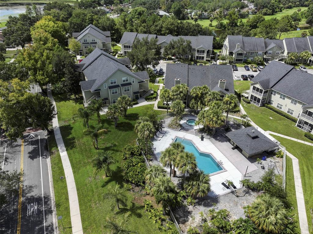 An aerial view of an apartment complex featuring a swimming pool, hot tub, and landscaping — 3721 S LAKE ORLANDO PARKWAY UNIT 8, ORLANDO, FL