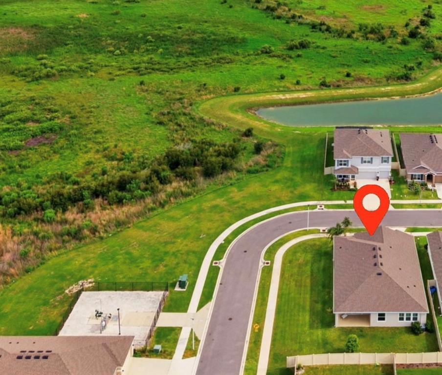 An aerial view shows a suburban house with a red location pin on the roof — 32337 CONCHSHELL SAIL STREET, WESLEY CHAPEL, FL