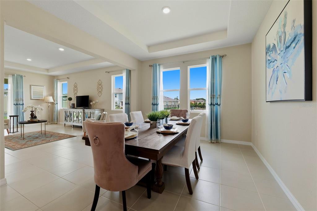 An aerial view shows a single-family home with a shingled roof and a fenced yard — 32337 CONCHSHELL SAIL STREET, WESLEY CHAPEL, FL