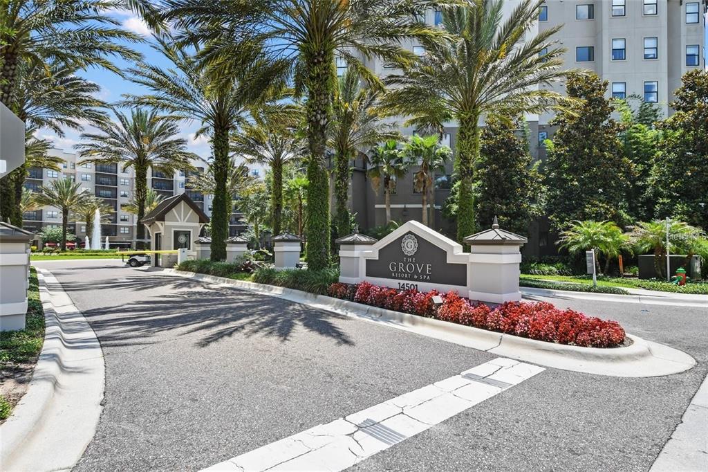 The entrance to The Grove Resort & Spa features a gated driveway with palm trees — 14501 GROVE RESORT AVENUE UNIT 2221, WINTER GARDEN, FL
