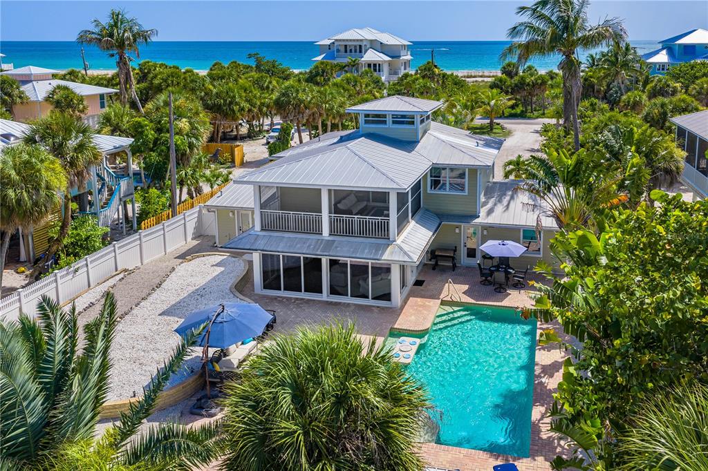 An aerial view of a two-story coastal house with a pool and patio — 550 N GULF BOULEVARD, PLACIDA, FL