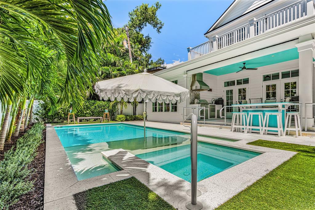 A backyard swimming pool and spa with a patio, outdoor bar, and white house exterior — 1426 S OSPREY AVENUE, SARASOTA, FL