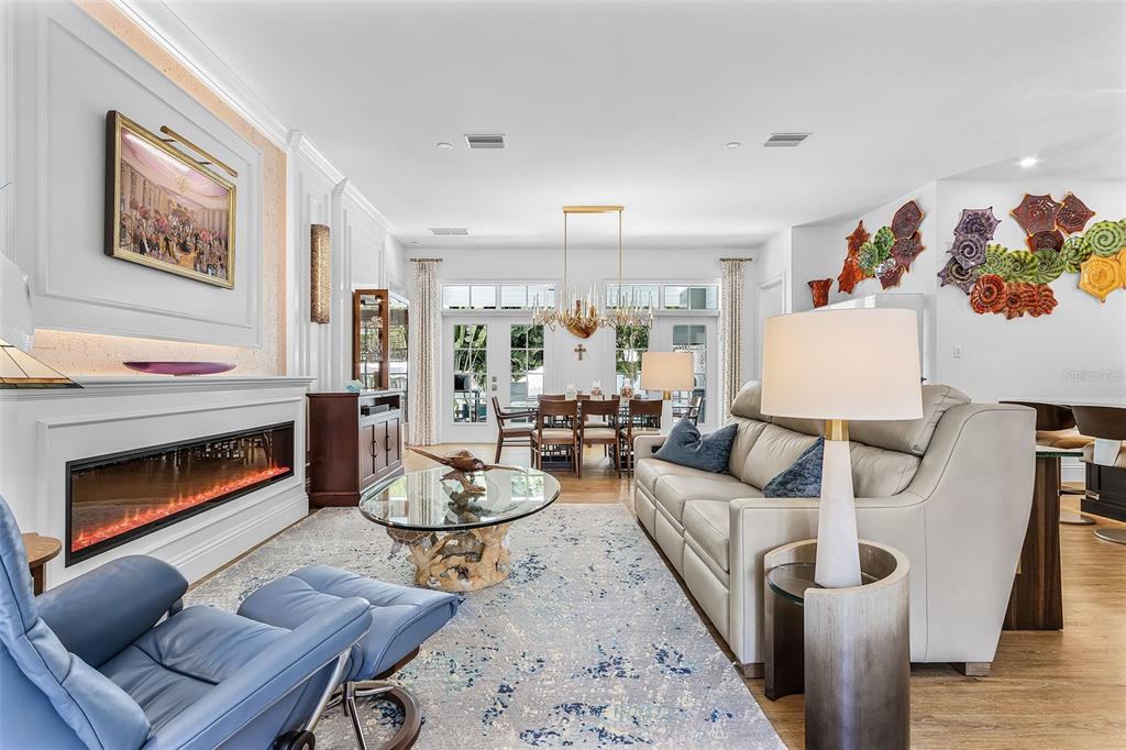 A living room features a fireplace, a blue leather recliner, and a light-colored sofa — 1426 S OSPREY AVENUE, SARASOTA, FL