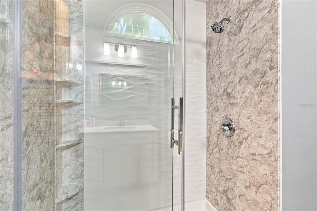 A bright entryway features a blue double door, high ceilings, tile flooring, and two armchairs — 16018 WILMINGTON PLACE, TAMPA, FL