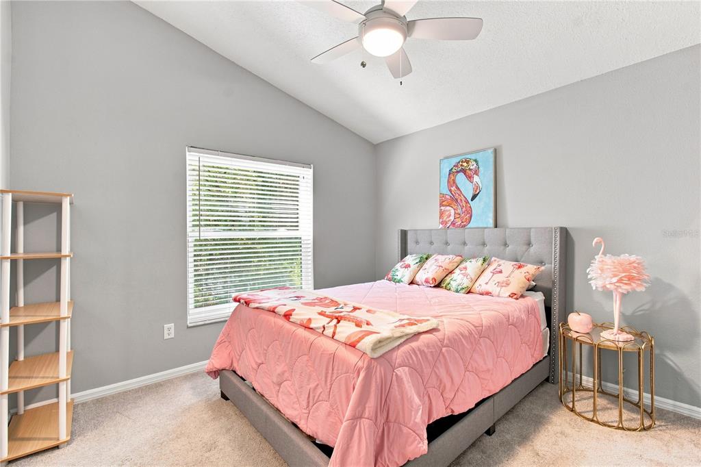 A sitting area features two armchairs, a patterned rug, and a large arched window — 16018 WILMINGTON PLACE, TAMPA, FL