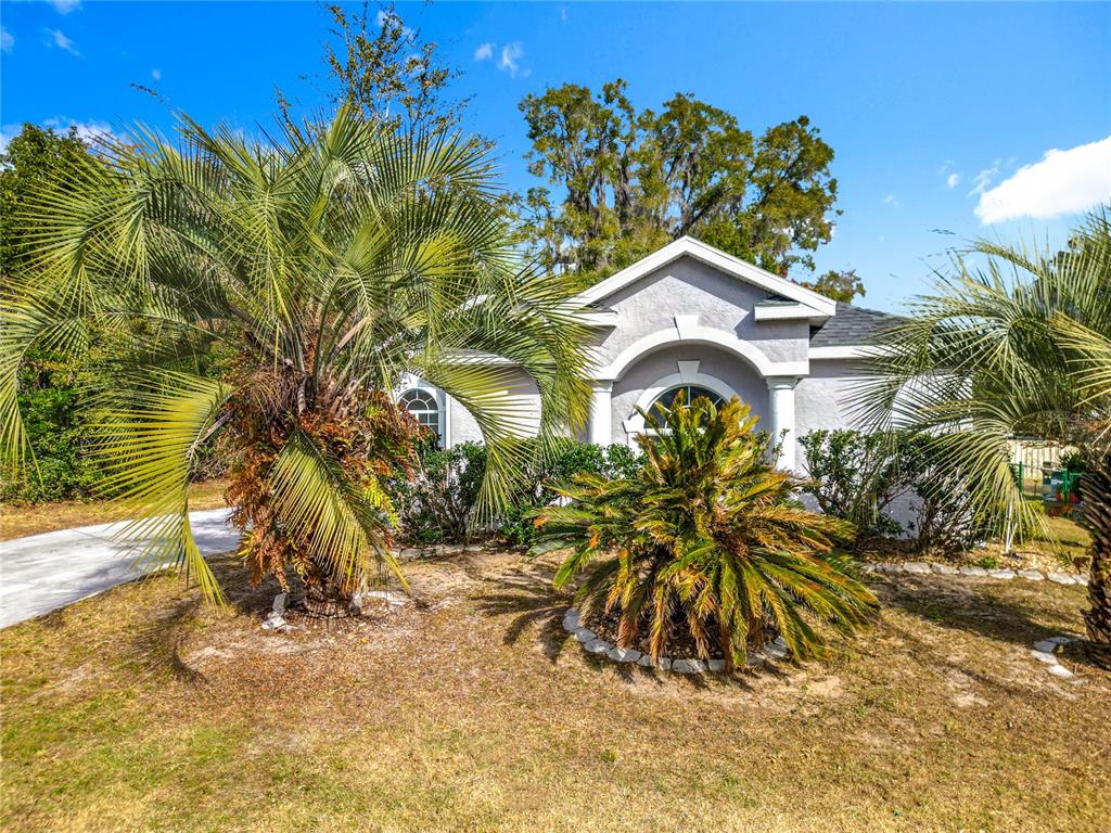 A single-story house with a light-colored stucco exterior, a two-car garage, and a front entrance — 5375 NW 26TH LANE, OCALA, FL