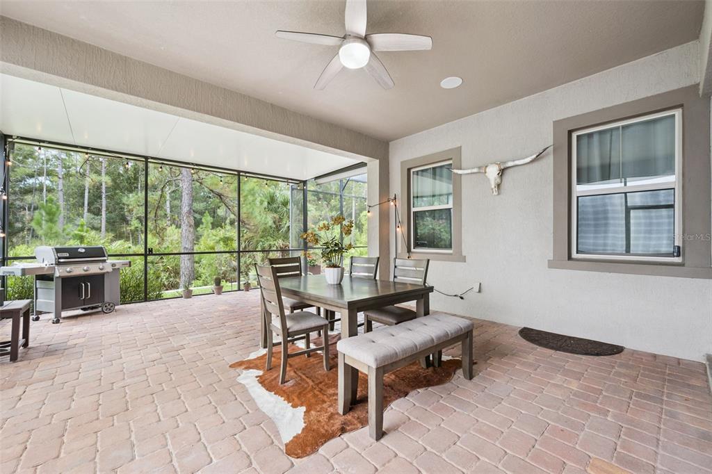 A two-story suburban house features a brick driveway, a two-car garage, and a palm tree — 14156 ALAFAYA OAK BEND, ORLANDO, FL