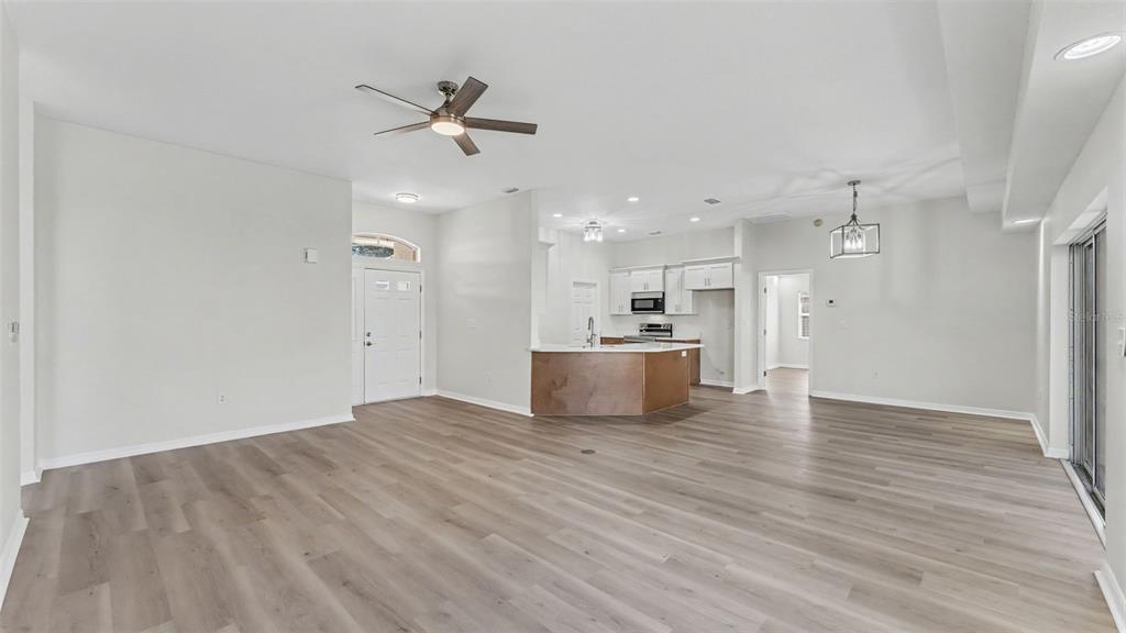 A single-story house with a beige exterior, tile roof, and a palm tree in the yard — 117 HARBOR WAY, AUBURNDALE, FL