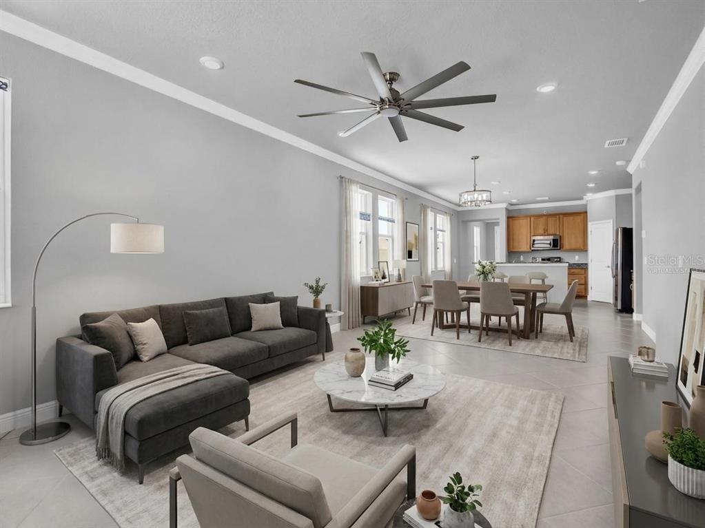 A bedroom features a tray ceiling, gray walls, carpeted flooring, and a bed with neutral bedding — 1461 N RIVER CIRCLE, TARPON SPRINGS, FL